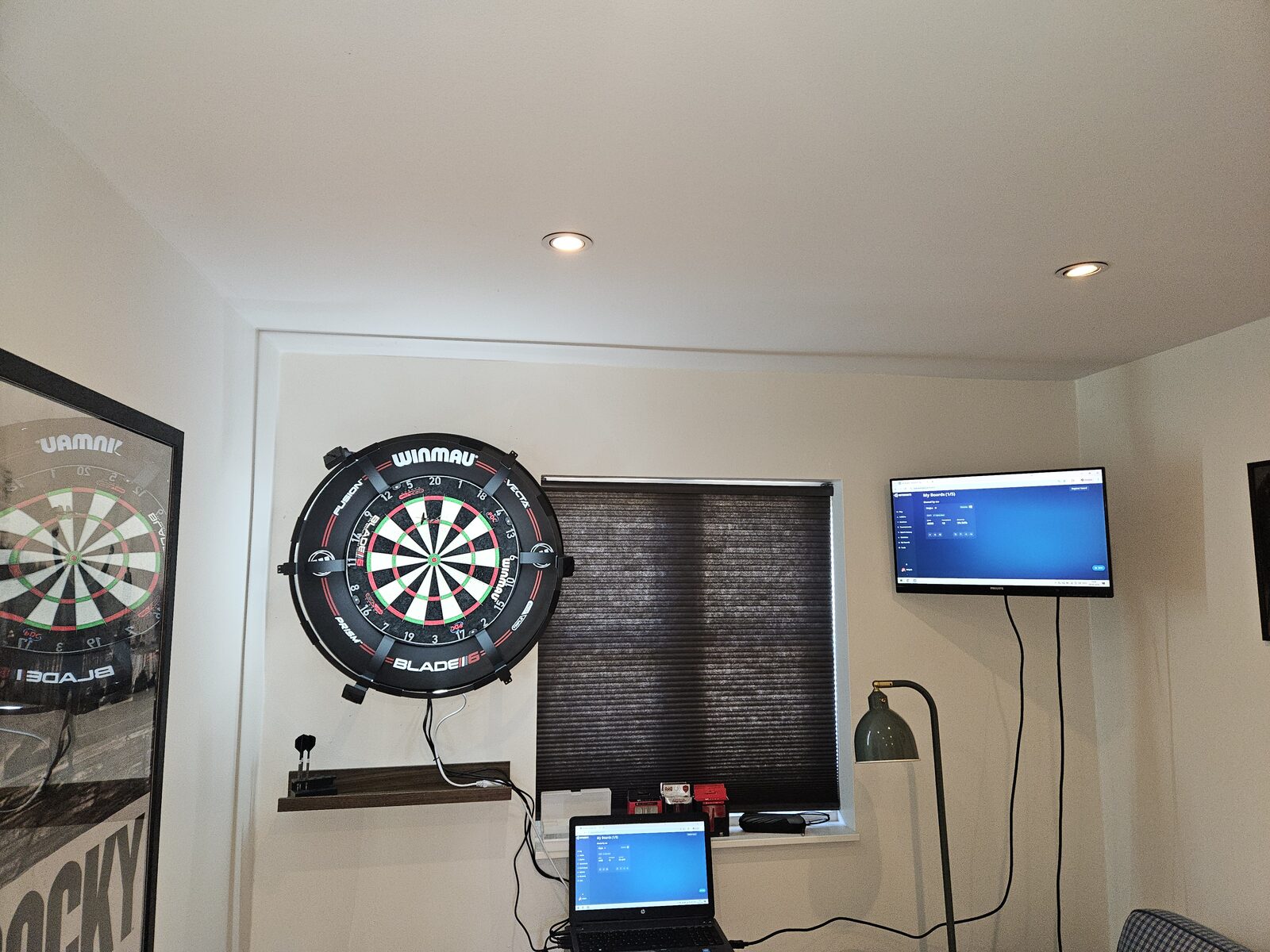 Mojos Dart Kit installed in a games room with scoring monitor and laptop